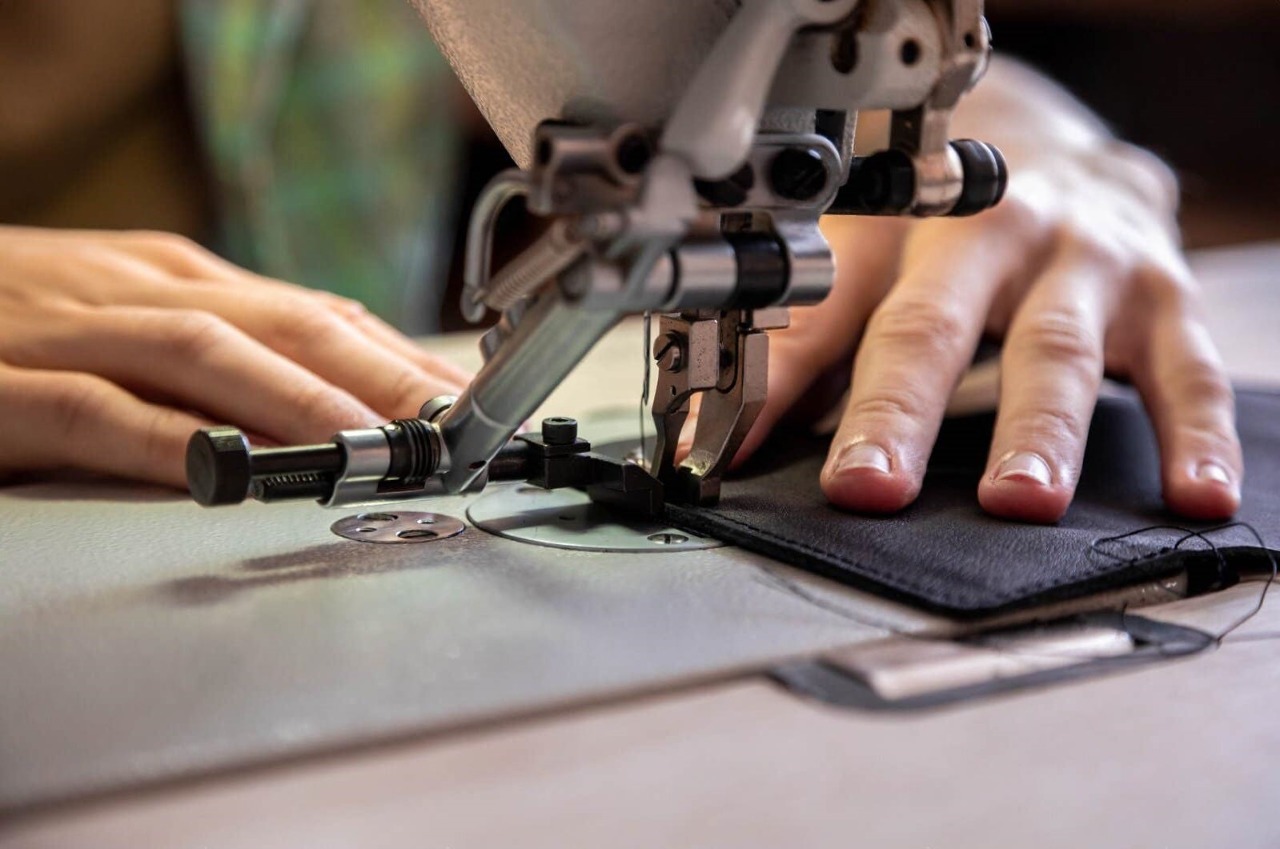 close up craftsman hands sew stuff blank wallet use sewing machine working leather workshop close up craftsman hands sew 222238265