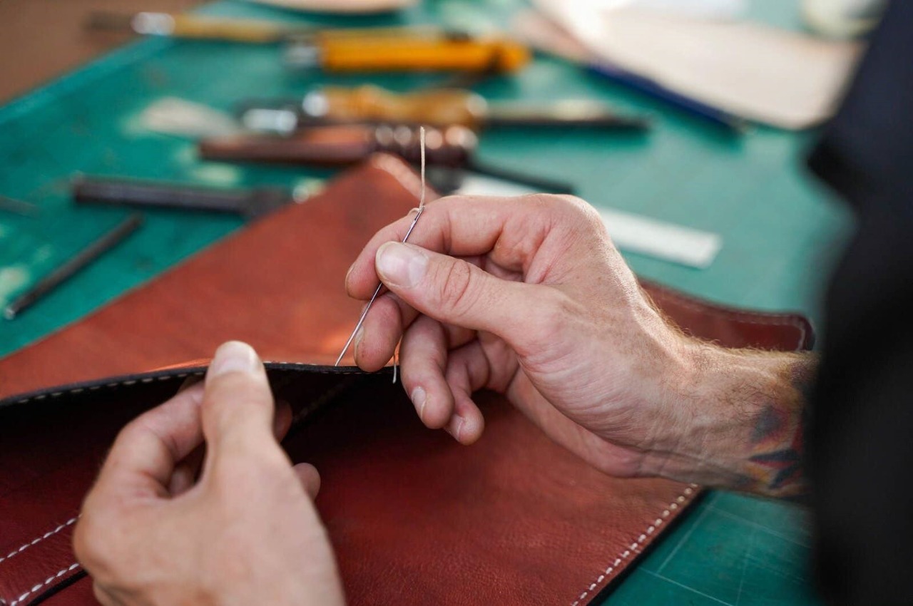 closeup hand leather craftsman carefully to sew leather bag customer leather craftsman concept closeup hand 271004938