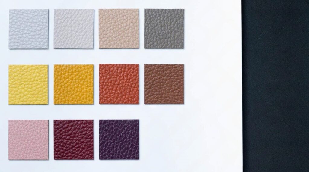 high quality italy vegetable leather sample different colors white gray camel brown wine pink purple black background 229974221